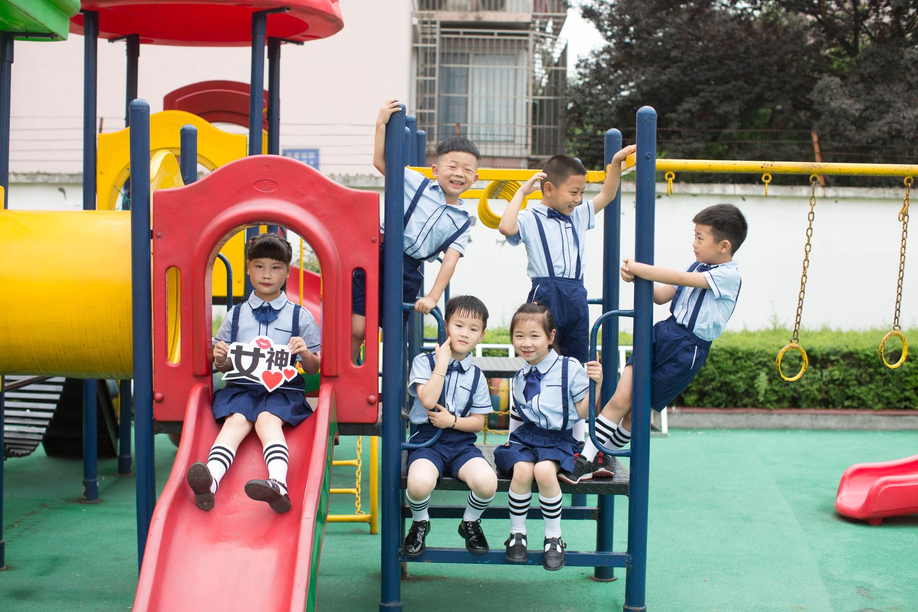 A group of children playing together at a colorful outdoor playground